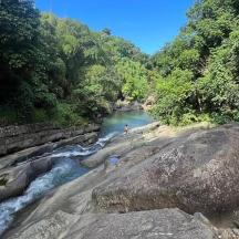 a person standing on a rock in a river