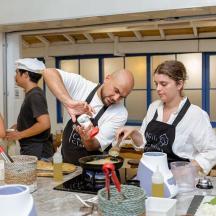 a group of people in a kitchen preparing food