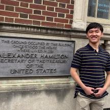 a young man standing in front of a building