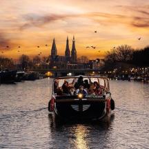 a group of people riding in a boat on a river