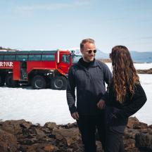 a man and a woman standing in front of a truck