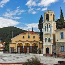 didelis geltonas pastatas su laikrodžio bokštu