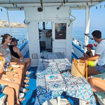 a group of people sitting on the back of a boat