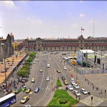 a busy city street with traffic in front of a building