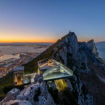 a train on top of a mountain at sunset