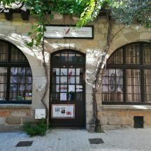 ein Gebäude mit drei Bogenfenstern und einer Tür