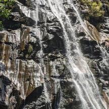 a waterfall on the side of a rocky mountain