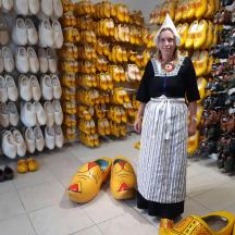 a woman standing in front of a store with shoes