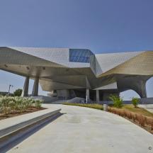 a building with a geometric roof with a pathway