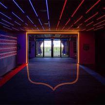 a dark room with a hallway with red and blue lights