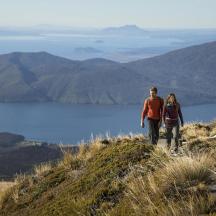 a man and a woman walking on a mountain