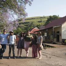 a group of people posing for a picture on a street
