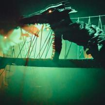 a skeleton of a dinosaur on a carnival ride at night