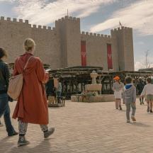 a group of people walking in front of a building