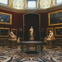 a room with statues and paintings on the walls