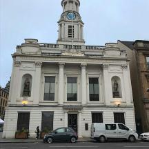 a white building with a clock tower on top of it
