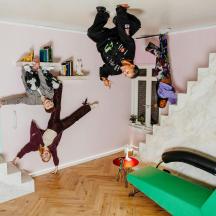 a group of people hanging on the wall in a room