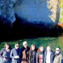 a group of people standing in front of a cave