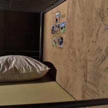 a pillow sitting on a bed next to a wall