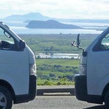 two white vans parked next to each other