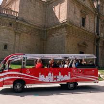 a group of people riding in a red bus