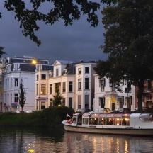 a boat on a river in front of a building