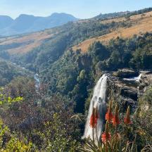 a waterfall in the middle of a valley