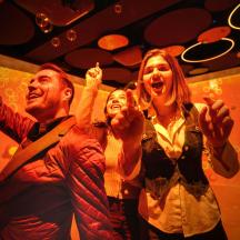 a group of people holding their hands in the air