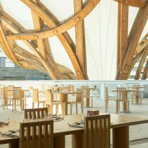 a dining room with wooden tables and chairs