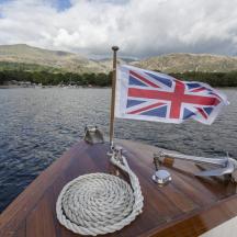 a boat with a british flag on the water