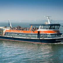 an orange and black boat in the water