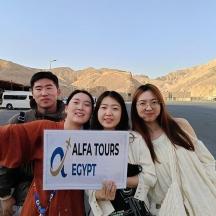 a group of people holding a sign in the desert