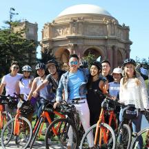 a group of people posing for a picture with their bikes