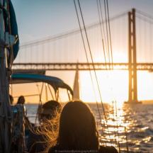 a group of people on a boat in front of a bridge