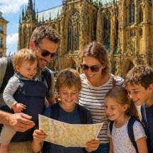 a family looking at a map in front of a cathedral