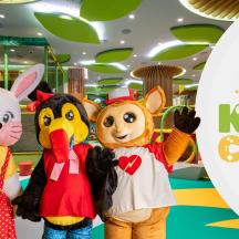 three cartoon mascots posing for a picture at an event