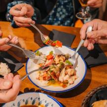 a group of people eating food on a table