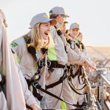 a group of people in uniform standing on a boat