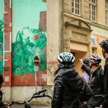 a group of people wearing helmets on their bikes