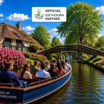 a group of people riding in a boat on a canal