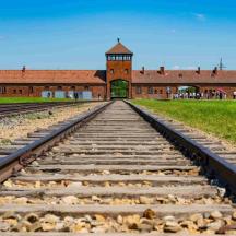 una via de tren buida davant d'un edifici de maó