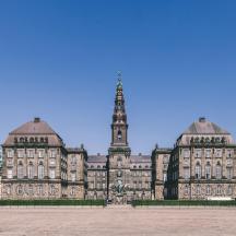 a large building with a clock tower in the distance