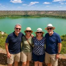 a group of people standing in front of a lake