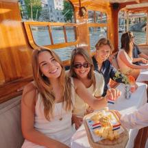 a group of people sitting at tables on a boat