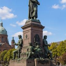 a statue of a man standing in front of a building