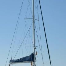 a boat with a blue tarp on its mast