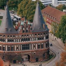 an old building with two pointed towers on a street