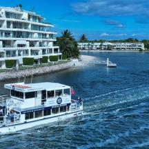 a boat on the water in front of a large building
