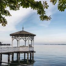 a gazebo on a pier on the water