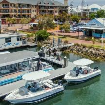 two boats docked at a dock in a marina